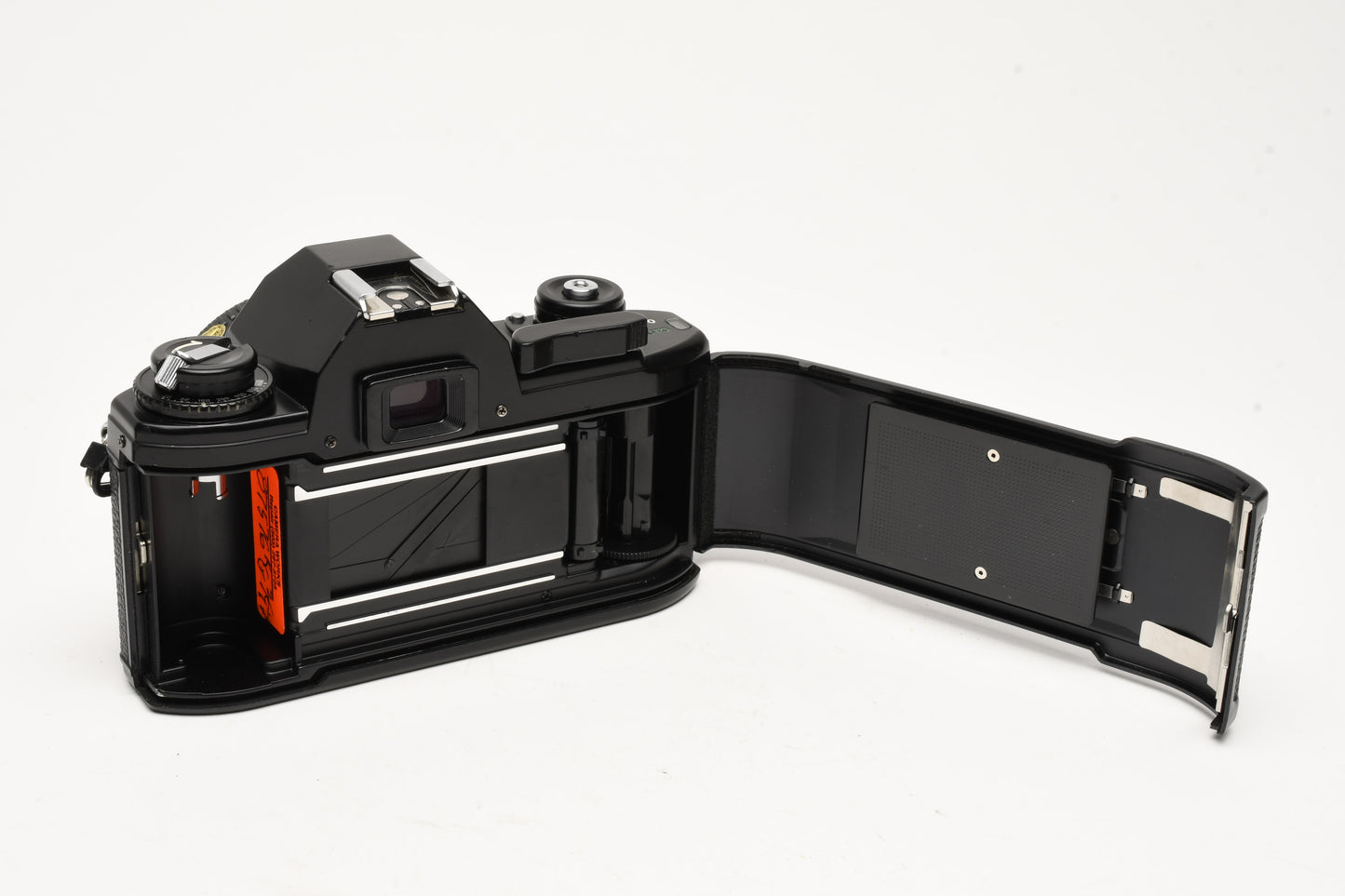 Nikon EM 35mm SLR w/Nikon Nikkor 50mm f1.8 lens, strap, cap, new seals