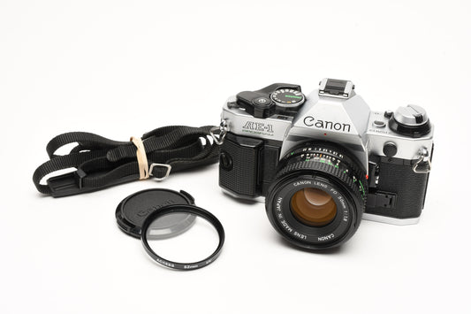Canon AE-1 Program 35mm SLR Camera w/50mm f1.8, New Seals, Grip, UV