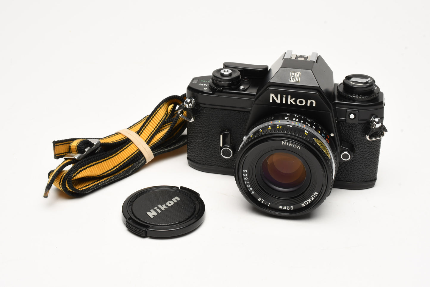 Nikon EM 35mm SLR w/Nikon Nikkor 50mm f1.8 lens, strap, cap, new seals