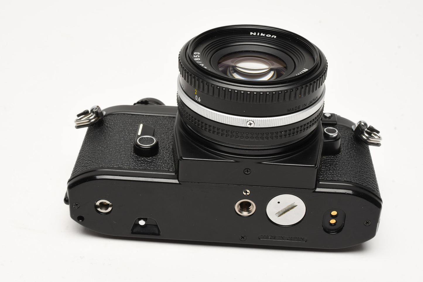 Nikon EM 35mm SLR w/Nikon Nikkor 50mm f1.8 lens, strap, cap, new seals