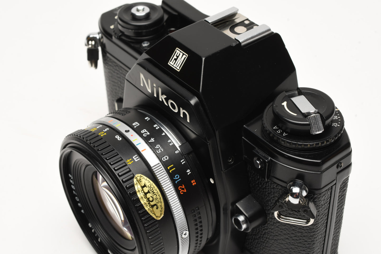 Nikon EM 35mm SLR w/Nikon Nikkor 50mm f1.8 lens, strap, cap, new seals