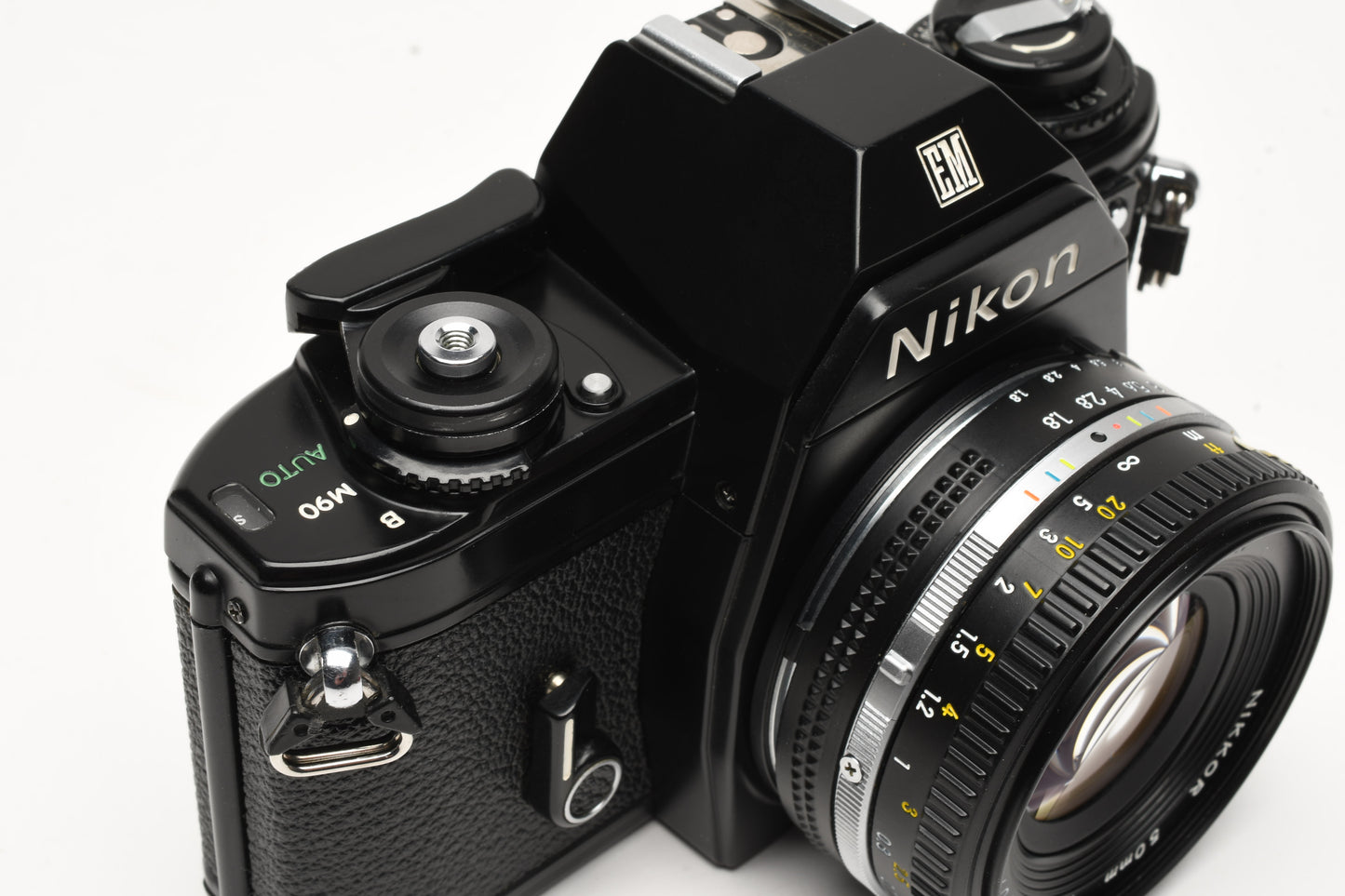 Nikon EM 35mm SLR w/Nikon Nikkor 50mm f1.8 lens, strap, cap, new seals