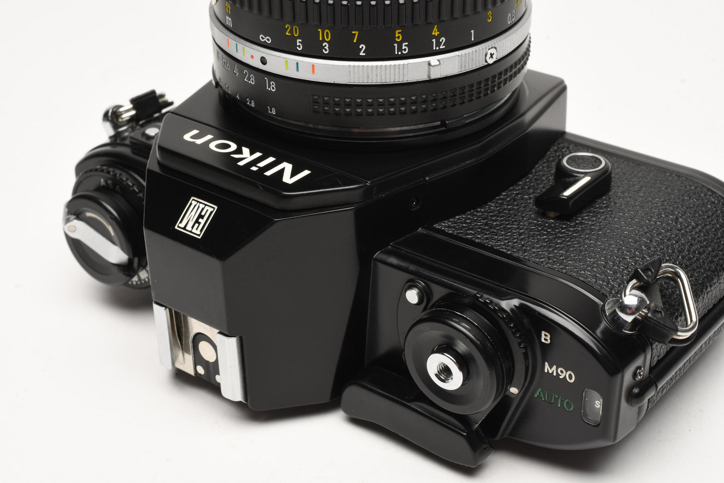 Nikon EM 35mm SLR w/Nikon Nikkor 50mm f1.8 lens, strap, cap, new seals