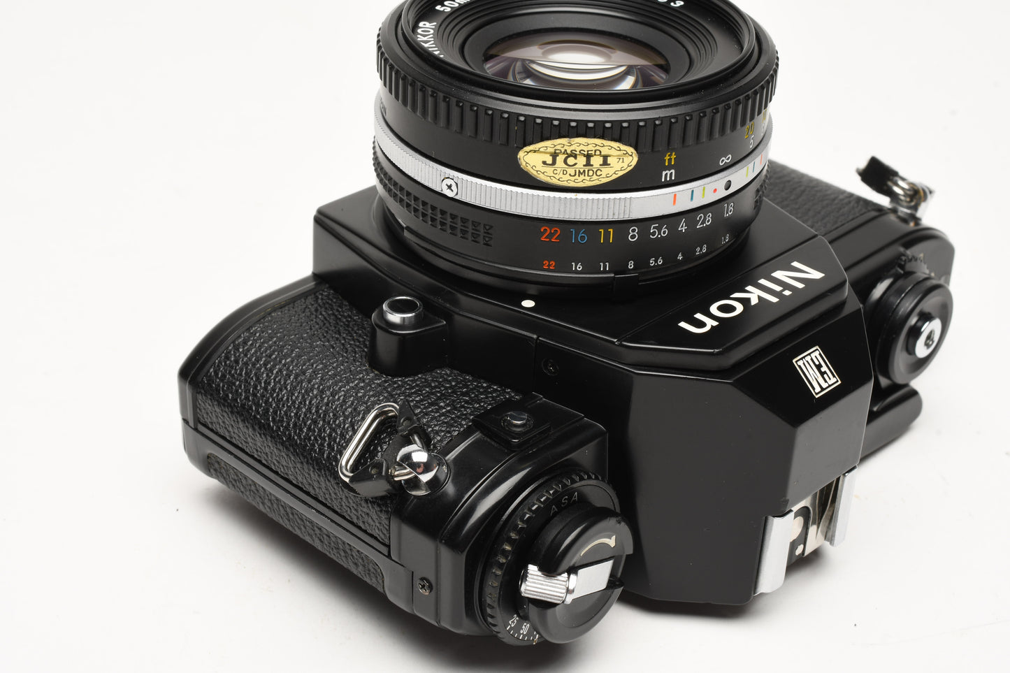 Nikon EM 35mm SLR w/Nikon Nikkor 50mm f1.8 lens, strap, cap, new seals