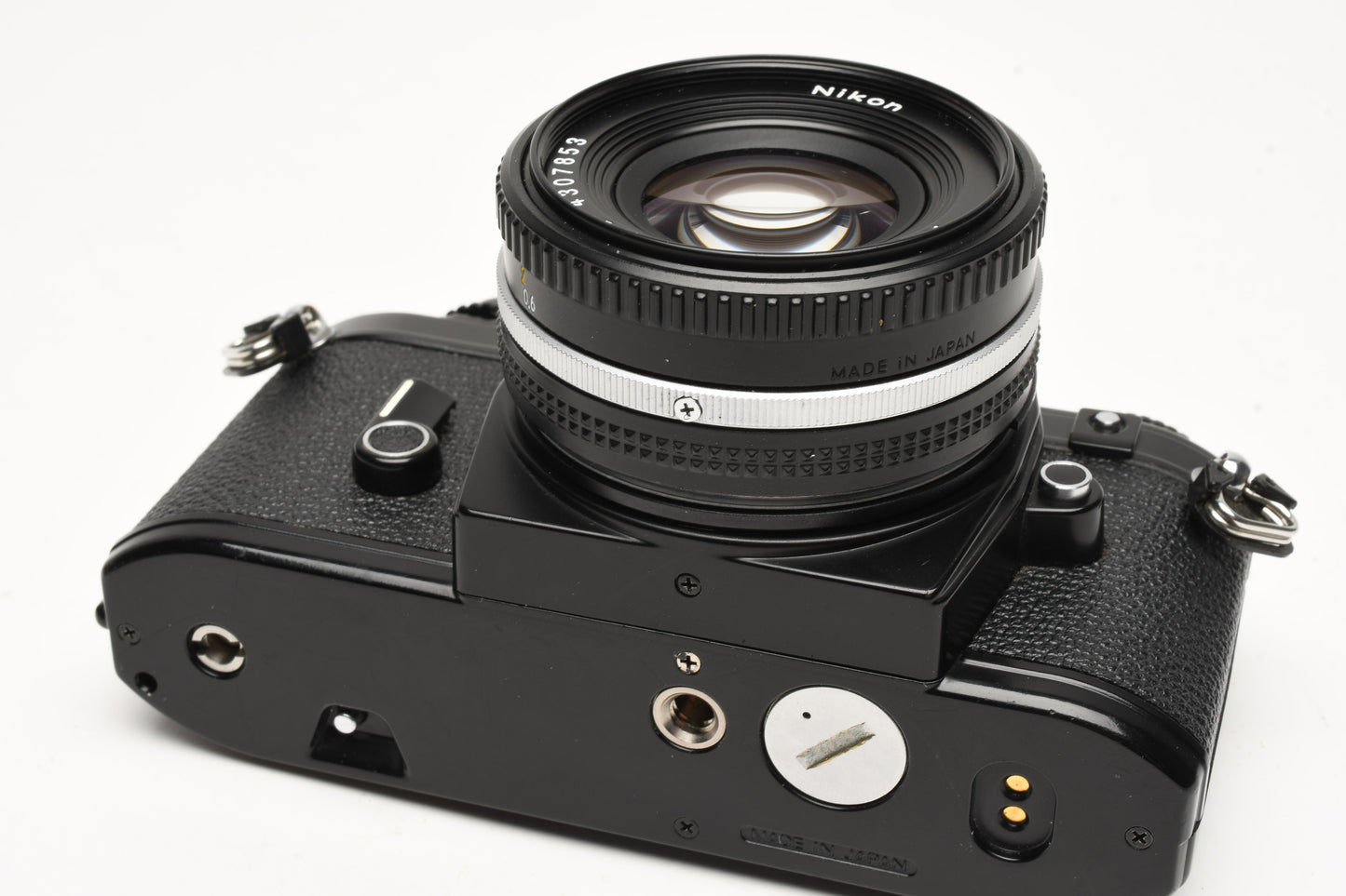 Nikon EM 35mm SLR w/Nikon Nikkor 50mm f1.8 lens, strap, cap, new seals