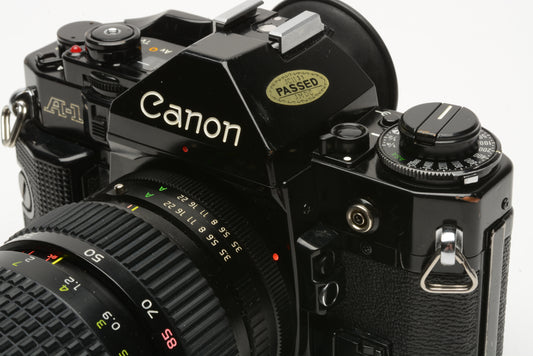 Canon A-1 35mm SLR w/Tokina 28-85mm f/3.5-4.5 lens + strap + cap + new seals