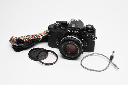 Nikon EM 35mm SLR w/Nikon Nikkor 50mm f1.8 lens, strap, cap, UV, CR, new seals