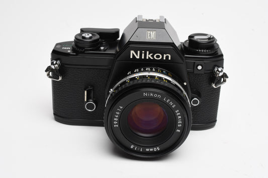 Nikon EM 35mm SLR w/Nikon Nikkor 50mm f1.8 lens, strap, cap, UV, CR, new seals