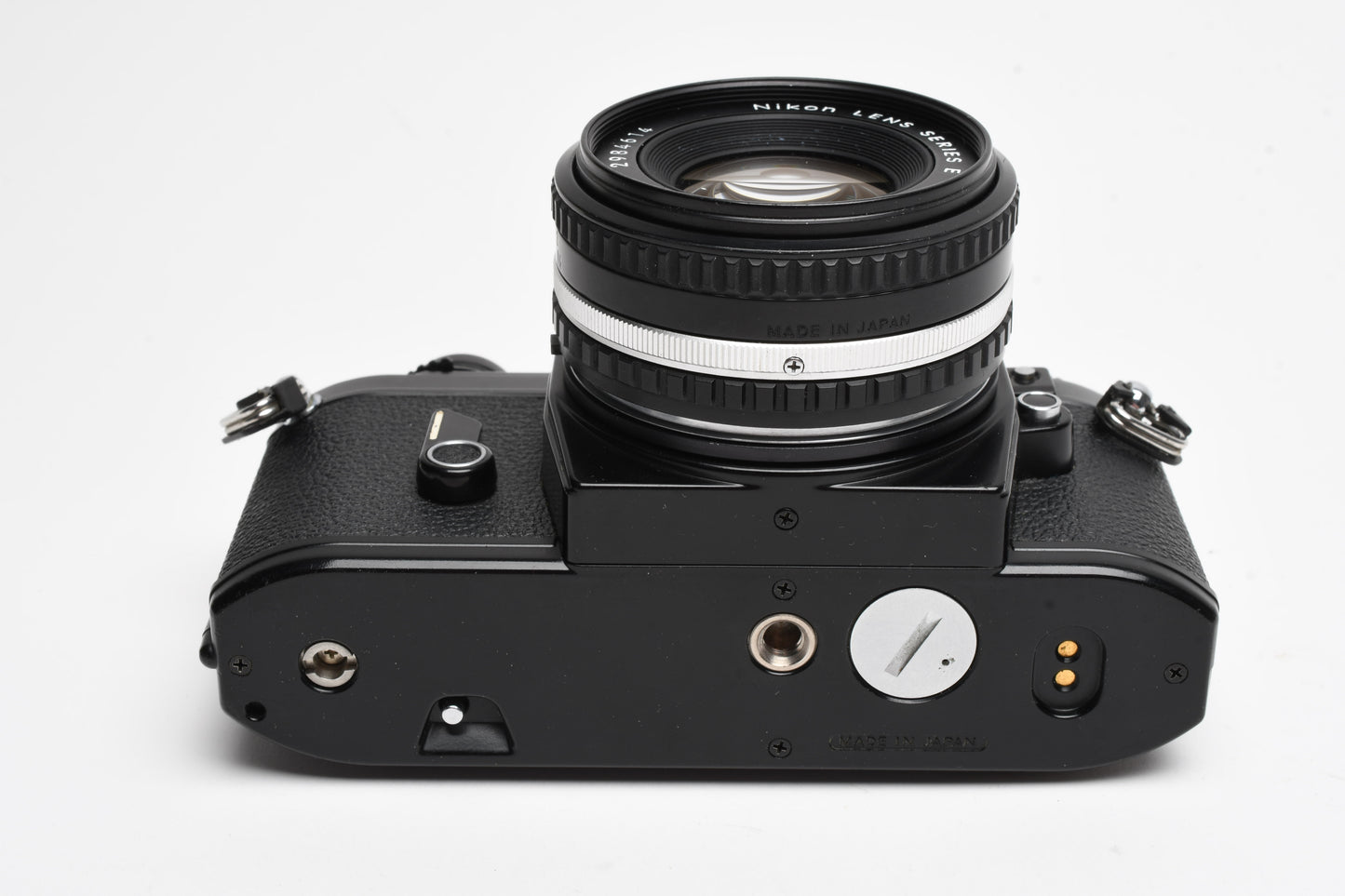 Nikon EM 35mm SLR w/Nikon Nikkor 50mm f1.8 lens, strap, cap, UV, CR, new seals