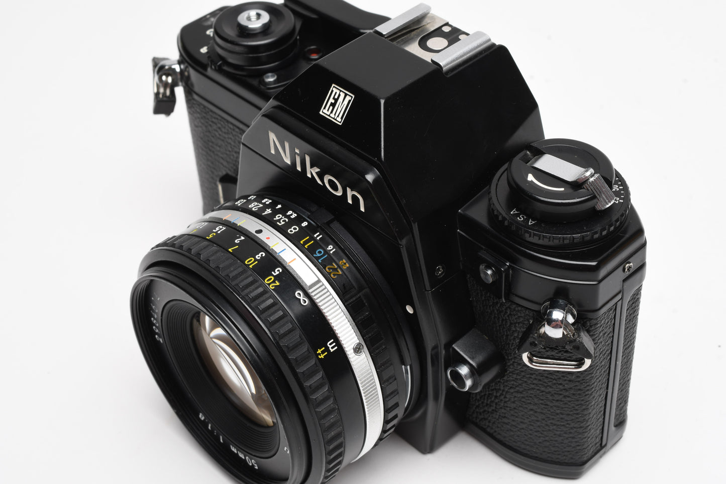 Nikon EM 35mm SLR w/Nikon Nikkor 50mm f1.8 lens, strap, cap, UV, CR, new seals