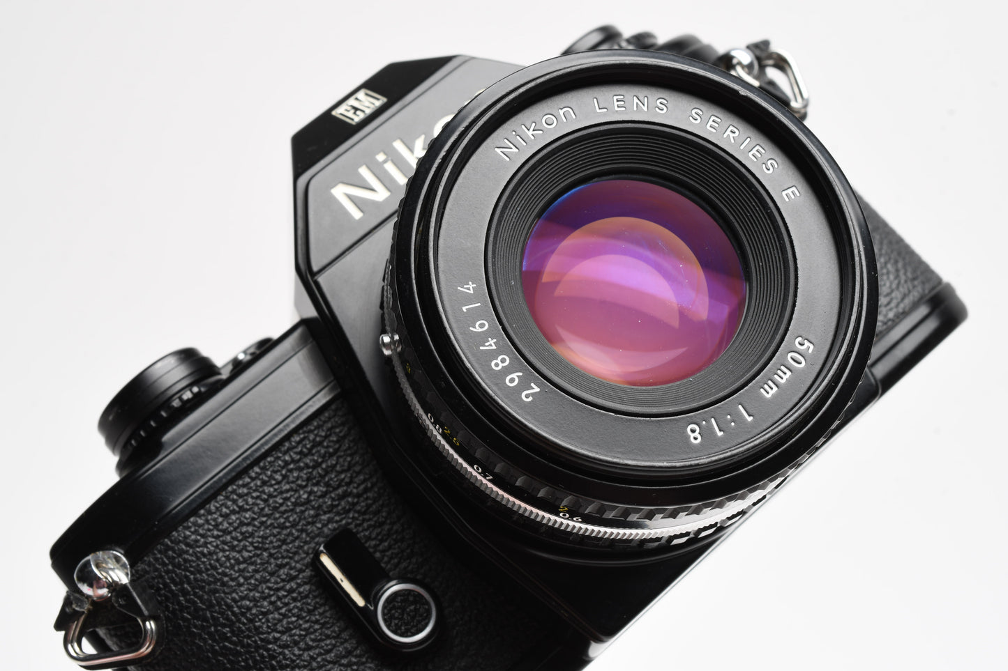 Nikon EM 35mm SLR w/Nikon Nikkor 50mm f1.8 lens, strap, cap, UV, CR, new seals
