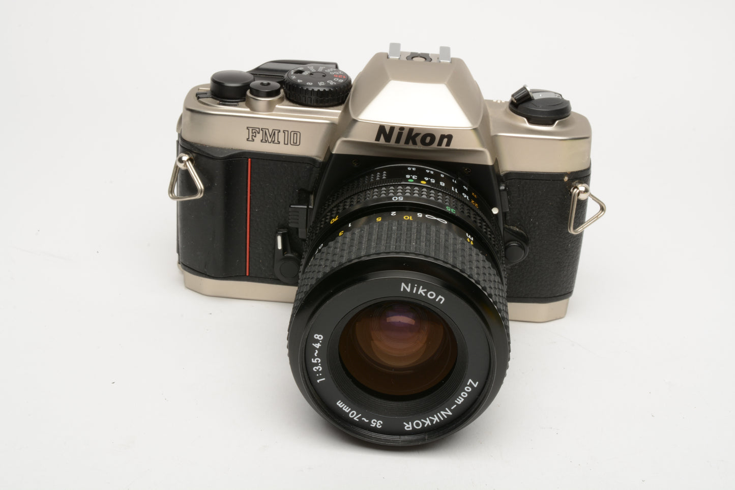 Nikon FM-10 35mm SLR w/35-70mm f3.5-4.8 zoom lens, cap+strap+pola, Great!