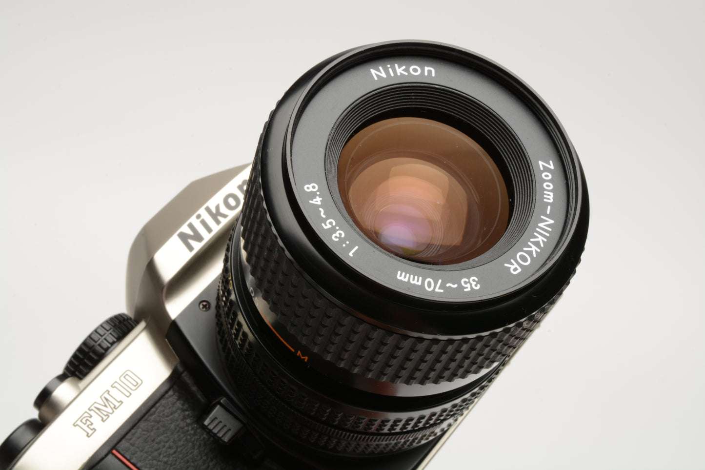 Nikon FM-10 35mm SLR w/35-70mm f3.5-4.8 zoom lens, cap+strap+pola, Great!