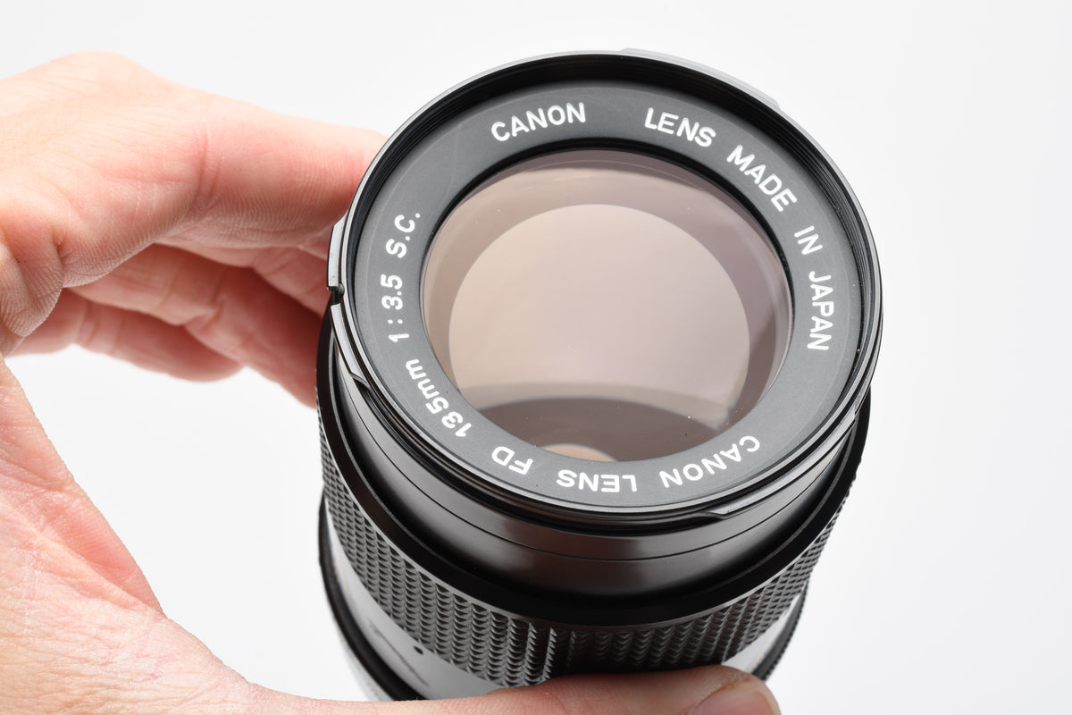 Canon 135mm F3.5 S.C. FD lens, caps, Sky, clean and sharp