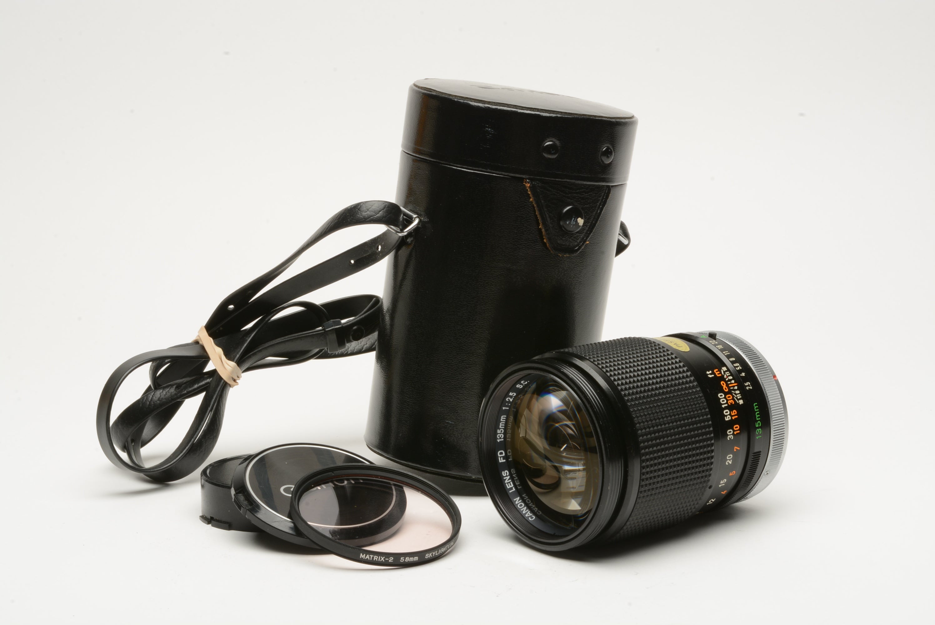 Canon 135mm f2.5 S.C. portrait lens, sky filter, caps, case, Very