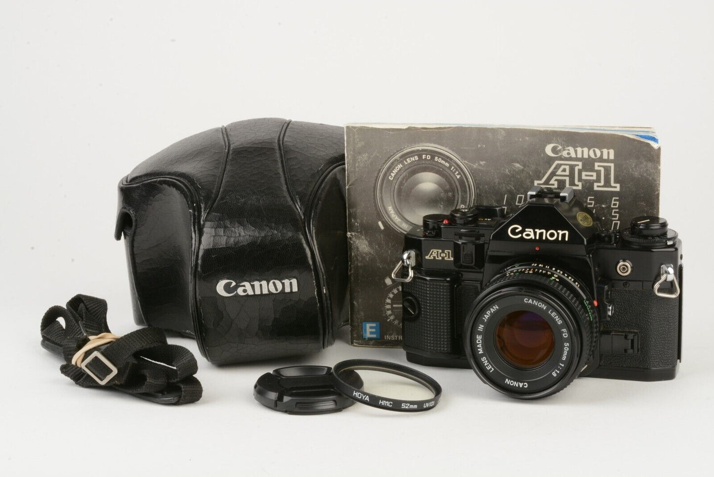 Canon A-1 35mm SLR w/50mm F1.8 lens, case, grip, strap, tested, new seals