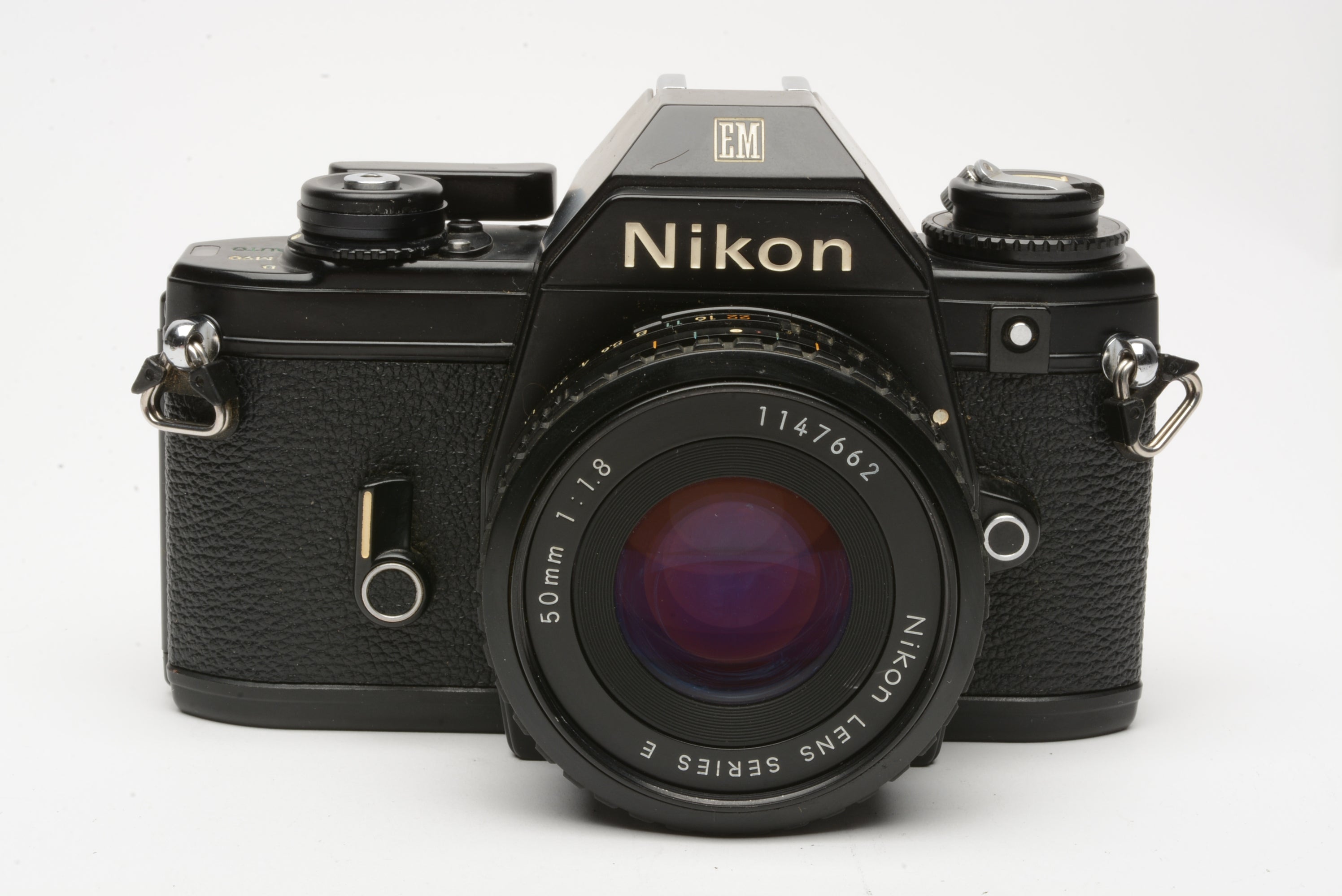 Nikon EM 35mm SLR w/Nikon Series E 50mm f1.8 lens, strap, cap