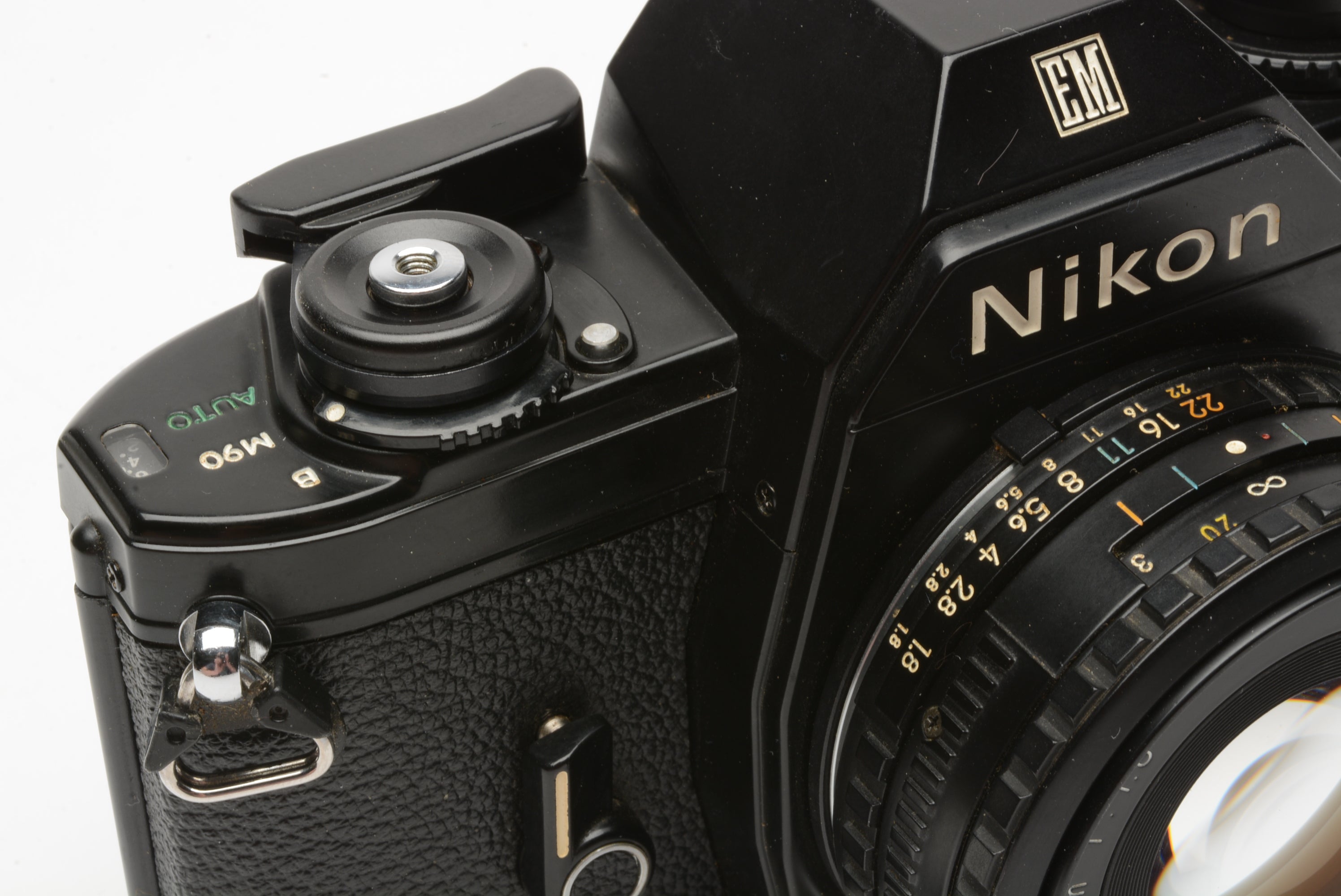 Nikon EM 35mm SLR w/Nikon Series E 50mm f1.8 lens, strap, cap